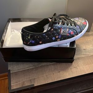 Black quilted pattern with different color flowers print it all over